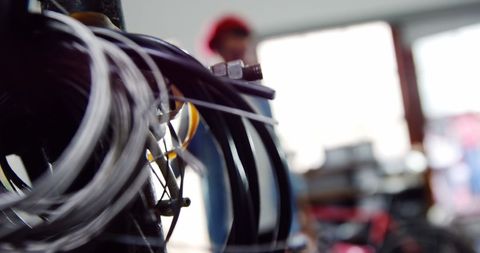 Blurry Mechanic with Bicycle Cables in Focus