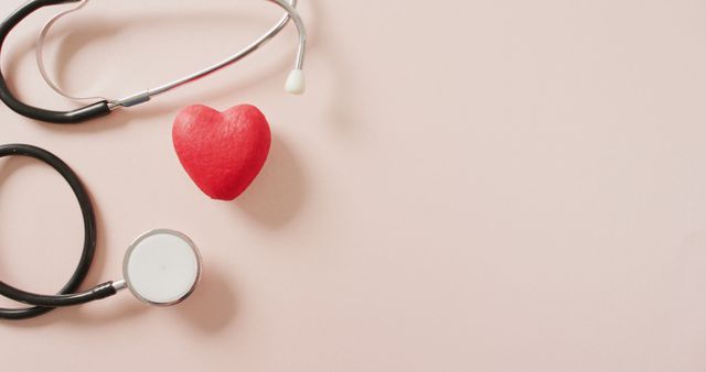 Red heart shape together with a stethoscope on a pastel background represents heart health and care. Ideal for healthcare promotions, heart health campaigns, medical websites, cardiology services, wellness content, and health checkup advertisements.