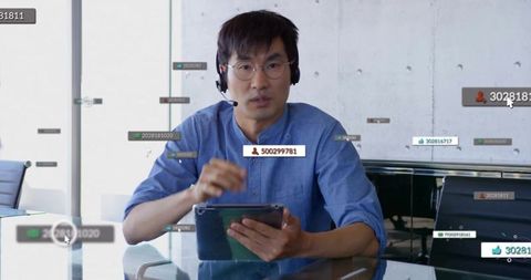 Professional Korean Man Engaging with Digital Data in Modern Office
