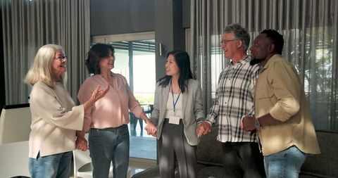 Inclusive group therapy session with multiracial participants smiling