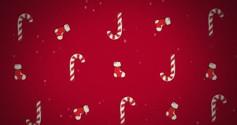 Festive christmas stockings and candy canes on red background