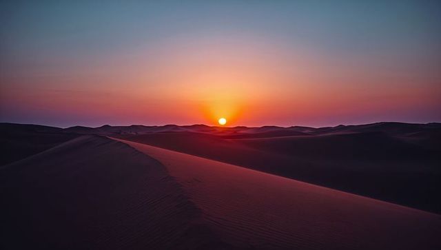 Breathtaking Desert Sunset Over Majestic Sand Dunes