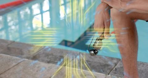 Swimmer Sitting Pool Edge Holding Mirrored Goggles Ready for Training or Competition