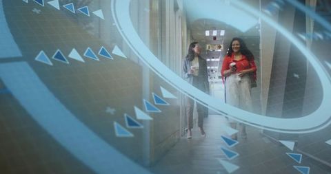 Coworkers walking and talking in office corridor, holding coffee with blue AR overlays