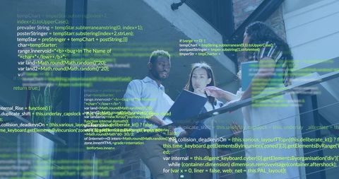 Tech team collaborating and reviewing code on atrium staircase with laptop notebook