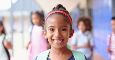 Smiling Girl in School Hallway with Backpack Ready for Learning - Download Free Stock Images Pikwizard.com