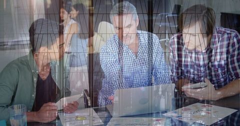 Business Professionals Reviewing Digital Data in Modern Office