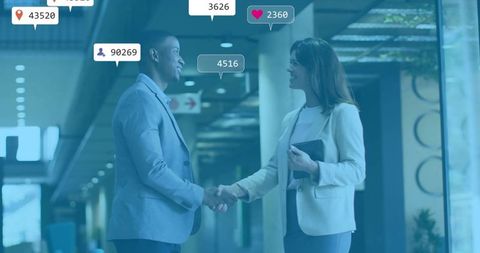 Business Professionals Shaking Hands in Digital Network Office Setting