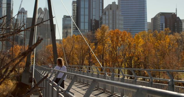 Woman Taking Selfie on Urban Bridge with Autumn Trees and Cityscape - Download Free Stock Images Pikwizard.com