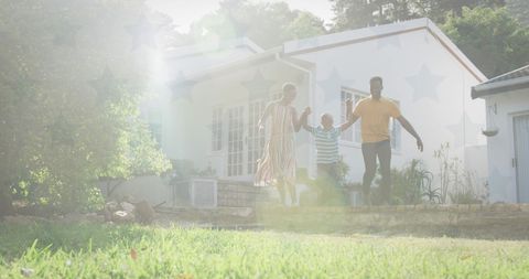 Happy Family Walking Together in Suburban Garden
