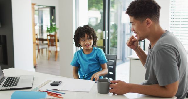 Father and Son Bonding Over Homework and Breakfast in Kitchen - Download Free Stock Images Pikwizard.com