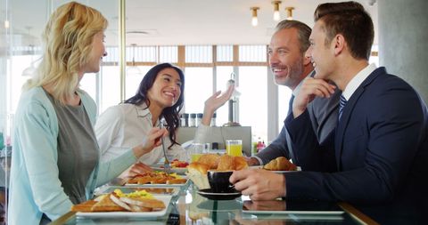 Group of Multiracial Professionals Socializing in Cafe Setting