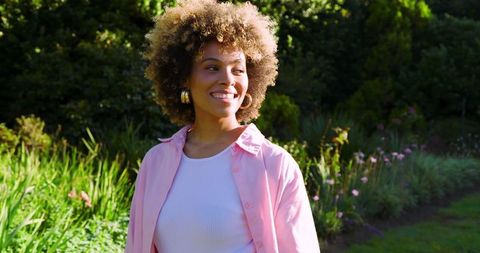 African American Woman Smiling Peacefully in Garden Landscape
