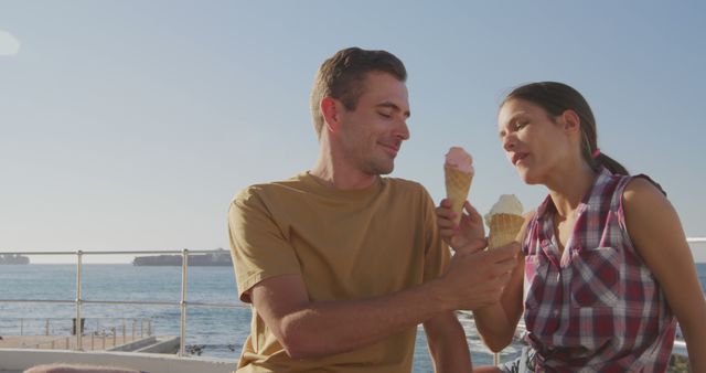 Couple Enjoying Ice Cream Treat by Ocean - Download Free Stock Images Pikwizard.com