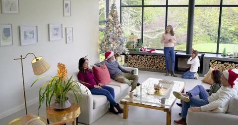 Multigenerational Multiracial Family Enjoying Cozy Modern Living Room Christmas Gathering