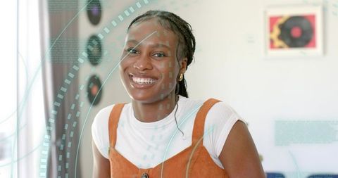 Joyful woman wearing vintage outfit with vinyl art background