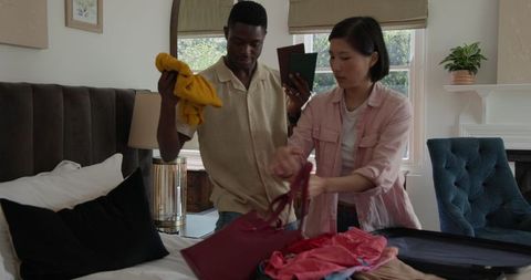 Diverse couple packing suitcase for exciting travel adventure