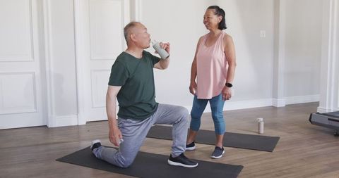 Senior Asian Couple Engaging in Exercise at Home for Wellness