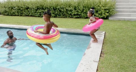 Children enjoying fun playtime with inflatable floats at poolside