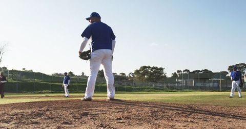 Baseball Players Posing on Field Under Clear Blue Sky
