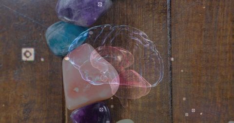 Holographic Brain Projection Over Gemstones on Wooden Table