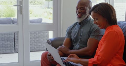 Mature Couple Enjoying Quality Time with Technology in Living Room - Download Free Stock Images Pikwizard.com