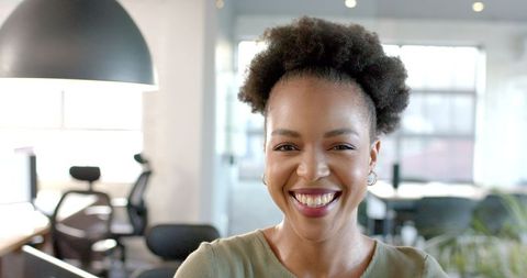 Confident African American Businesswoman Smiling in Studio Office Environment