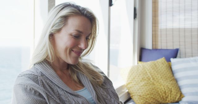 Happy Woman Relaxing by Window with Ocean View - Download Free Stock Images Pikwizard.com