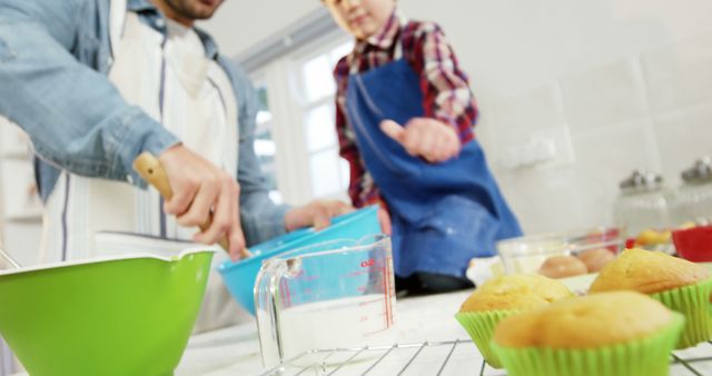 Father and son baking muffins together in kitchen - Download Free Stock Images Pikwizard.com