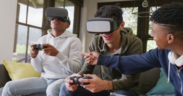 Young friends enjoying virtual reality gaming together in a cozy living room. Great for use in articles or promotions related to technology, VR games, home entertainment, social activities, or youth lifestyle.