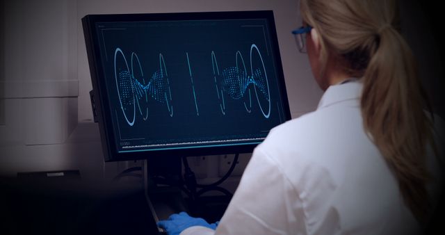 Rear view of doctor looking dna molecule on computer in hospital