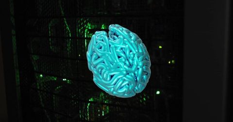 Futuristic blue brain model with green digital glow