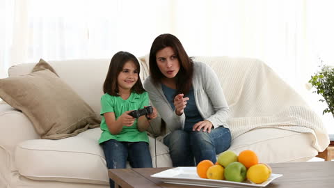 Mother and Daughter Bonding While Playing Video Games at Home