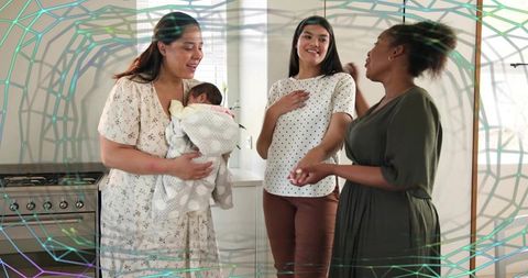 Multicultural women bonding with newborn in bright modern kitchen celebrating motherhood