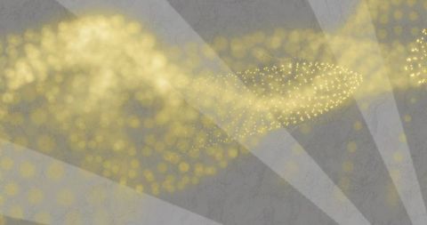 Flowing golden particle stream creating shimmering bokeh over textured gray backdrop