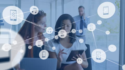 Businesswomen Exploring Global Networking on Digital Tablet in Modern Office