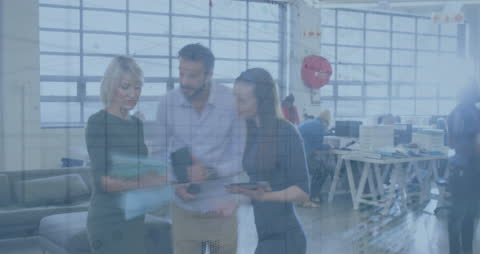 Businesspeople Collaborating in Modern Office with Financial Data Overlay