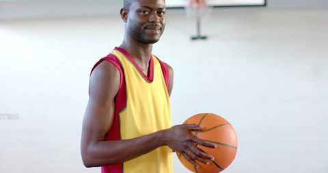 Male Athlete with Basketball on Gym Court