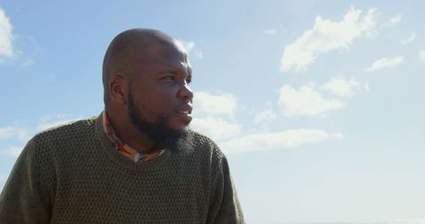 Pensive Man Reflecting Outdoors Under Clear Sky