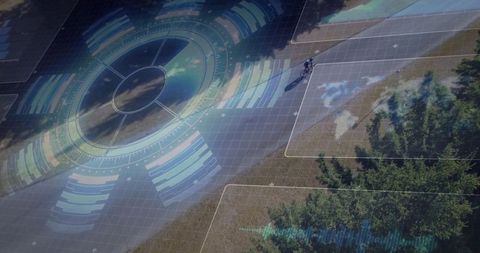 Aerial perspective teen riding bike on park path with futuristic hud overlays