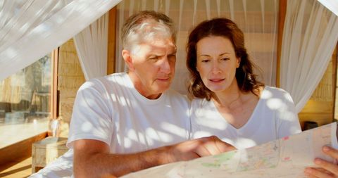 Middle-Aged Caucasian Couple Planning Journey with Map - Download Free Stock Images Pikwizard.com
