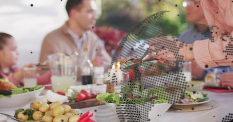 Serving fresh salad at family outdoor lunch on sunlit garden patio, casual gathering