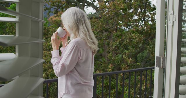 Senior Woman Drinking Coffee on Balcony with Nature View - Download Free Stock Images Pikwizard.com