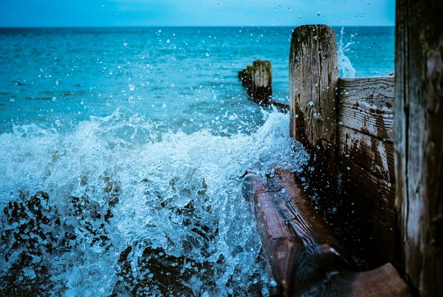 Ocean Waves Splashing Against Wooden Pier - Download Free Stock Photos Pikwizard.com