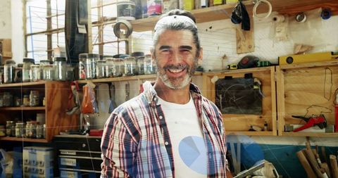 Smiling Male Carpenter in Workshop with Digital Elements Overlay
