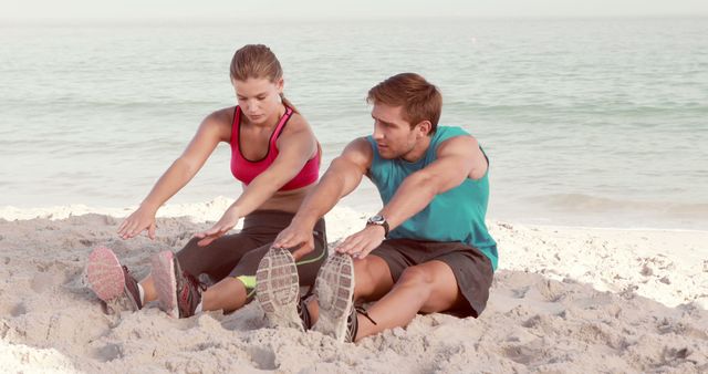 Couple Stretching on Beach During Morning Workout - Download Free Stock Images Pikwizard.com