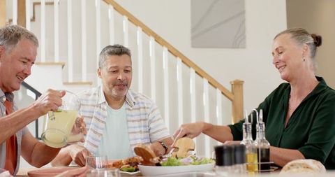 Senior Friends Enjoying Dining with Drinks and Salad