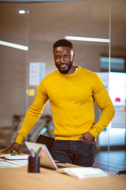 Portrait of african american male business creative looking to camera and smiling. independent creative business people at a modern office.