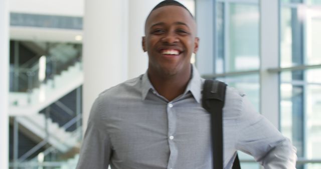 Smiling Businessman with Briefcase in Modern Office Building - Download Free Stock Images Pikwizard.com