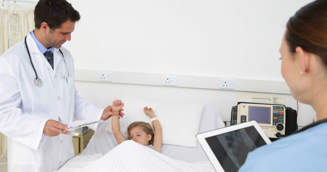 Male Doctor And Female Nurse Examining Young Patient In Hospital Bed - Download Free Stock Images Pikwizard.com